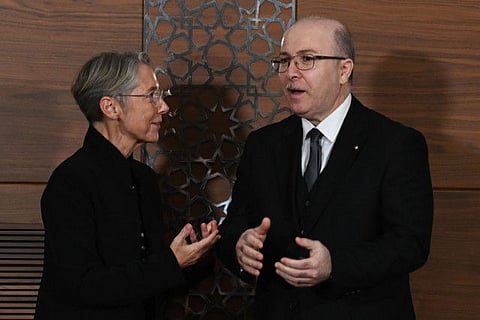French Prime Minister Elisabeth Borne speaks with Algerian Prime Minister Aymen Benabderrahmane prior to deliver a joint statement in Algiers on October 9, 2022.