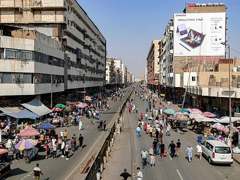 People walk and shop at the Shorja market in the centre of Iraq's capital Baghdad on October 7, 2022.