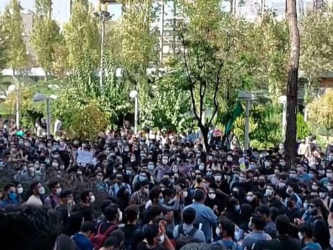 This grab taken from a UGC video made available on the ESN platform on October 10, 2022 shows Iranian students chanting slogans as they protest at Tehran's Amirkabir University of Technology.