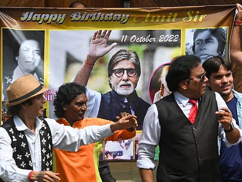 Fans and wellwishers of Bollywood actor Amitabh Bachchan dance outside his house on the occasion of his 80th birthday in Mumbai on October 11, 2022.