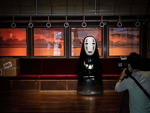 A member of the media takes a video of an exhibit at Ghibli's Grand Warehouse during a media tour of the new Ghibli Park in Nagakute, Aichi prefecture on October 12, 2022.