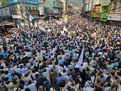 People take part in a protest rally to condemn the killing of a school van driver in Mingora, Swat Valley.