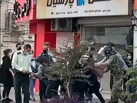 This image grab from a UGC video made available on October 12, 2022 shows women protesters being roughly handled by Iranian security forces in the city of Rasht, in Iran's northern Gilan province.