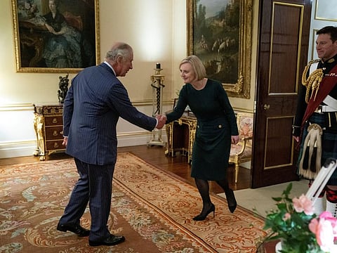 Britain's King Charles shakes hands with British Prime Minister Liz Truss during their weekly audience at Buckingham Palace in London, Britain, October 12, 2022.