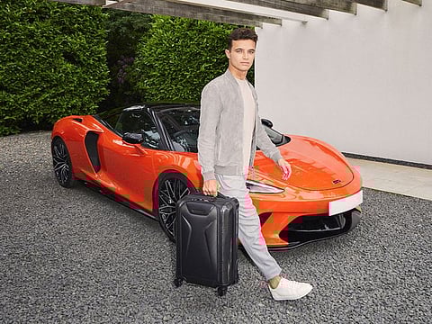 McLaren F1 driver Lando Norris with the new TUMI luggage engineered in CX6, an exclusive carbon fibre material.