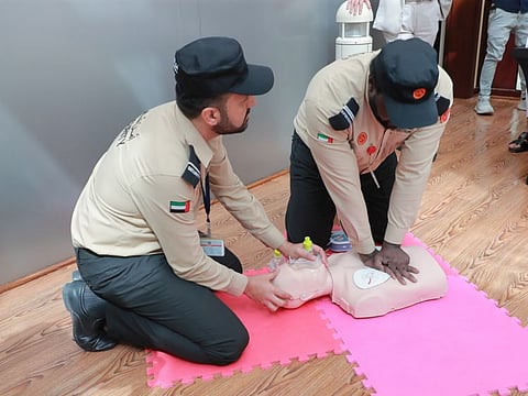 Security guards demonstrating CPR at the event at RAK Hospital where around 100 security guards have received free BLS-certified first aid training to be the qualified first responders in emergency situations
