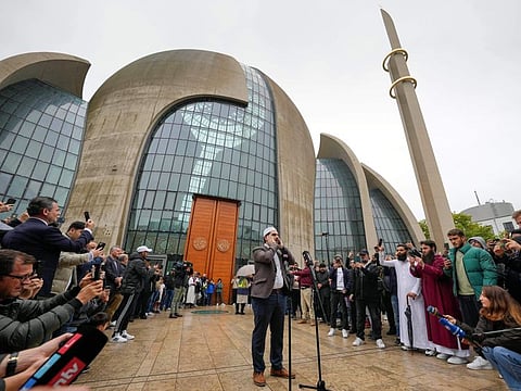 Muezzin Mustafa Kader recites the call to prayer at the Cologne Central Mosque in Cologne, on October 14, 2022.