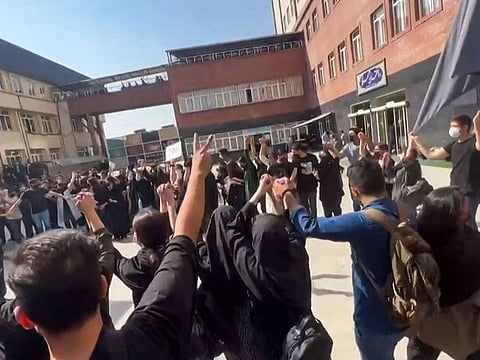 This image grab from a UGC video made available on October 15, 2022, shows Iranian students chanting "Freedom" as they rally at Tehran's University of Science and Culture.