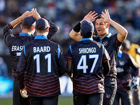 Namibia's JJ Smit (right) and teammates celebrate the wicket of Sri Lanka's Chamika Karunaratne during the Australia 2022 Twenty20 World Cup cricket match at Kardinia Park in Geelong. Namibia, ranked 14th in the world, shocked Asia Cup champions Sri Lanka to win by 55 runs.