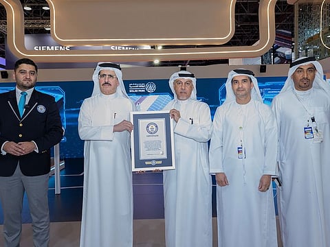 Saeed Mohammed Al Tayer and other officials hold up the Guinness World Record certificate for the Jebel Ali Power Generation and Water Production Complex.