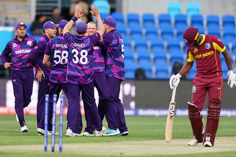 Scotlands Michael Leask (centre) celebrates with teammates after dismissing West Indies captain Nicholas Pooran during the Australia 2022 Twenty20 World Cup cricket match at Bellerive Oval in Hobart. Scotland won by 42 runs.
