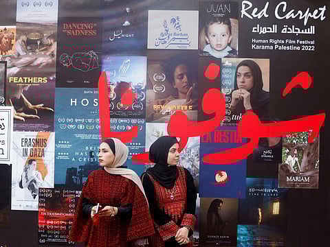 Palestinian volunteers participate in organising the sixth edition of the Red Carpet Film Festival, at a newly renovated theatre in Gaza City, October 13, 2022.