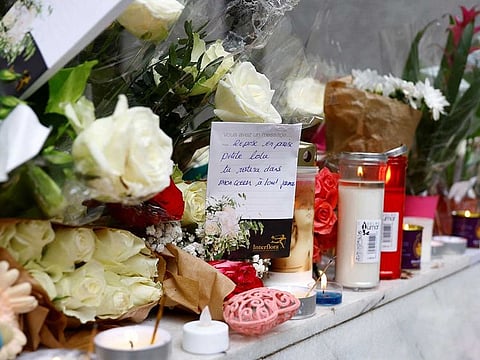 Flowers with a hand-written message which reads "Rest in peace little Lola, you will stay in my heart forever" are displayed outside the building where a 12-year-old schoolgirl Lola lived, who was brutally killed and whose body was stuffed in a trunk in the 19th district in Paris, France, October 18, 2022.