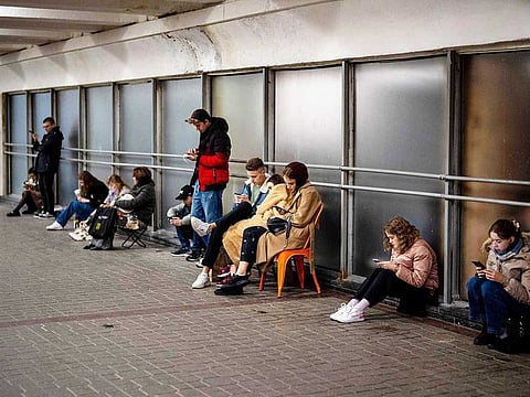 People sit in the Kyiv subway, using it as a bomb shelter, in Kyiv, Ukraine, on Wednesday, Oct. 19, 2022.