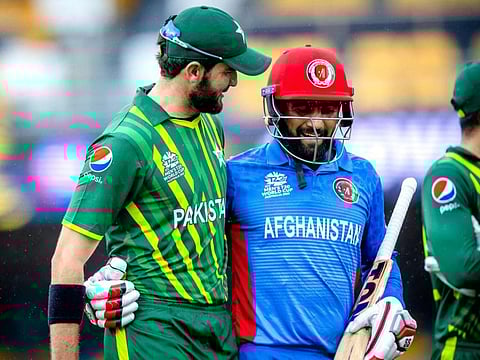 Pakistan left-arm pacer Shaheen Shah Afridi (left) talks to Afghanistan's Usman Ghani at the end of the innings during the warm-up match at the Gabba in Brisbane on Wednesday.