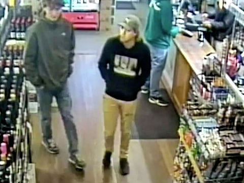 This image from CCTV provided Monday, June 17, 2019, by New South Wales Police Force, missing Belgian backpacker Theo Hayez, center, wearing black hooded jumper, inside liquor store in Byron Bay, Australia on May 31, 2019.