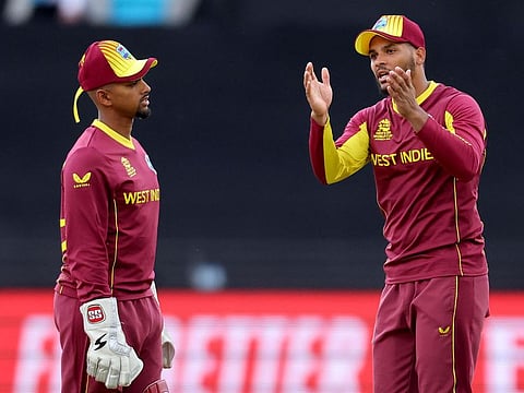 West Indies captain Nicholas Pooran (left) talks to Brandon King the during the ICC men’s Twenty20 World Cup 2022 cricket match against Ireland at Bellerive Oval in Hobart on October 21, 2022. Pooran’s poor handling of the bowling resources was a factor in West Indies’s defeats.