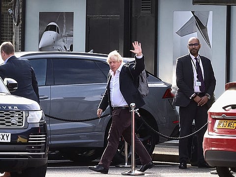Former British Prime Minister Boris Johnson at Gatwick Airport, near London, on October 22, 2022.  Boris Johnson arrived back in Britain on Saturday as he considers an audacious attempt to win a second term as prime minister only weeks after he was forced to step down, with some colleagues warning his comeback could create more political chaos.