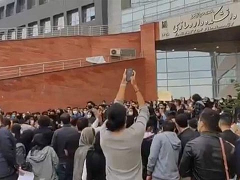 This image grab from a UGC video made available on Twitter reportedly on October 22, 2022 shows students protesting outside the University of Medical Sciences in Iran's northwestern city of Tabriz.