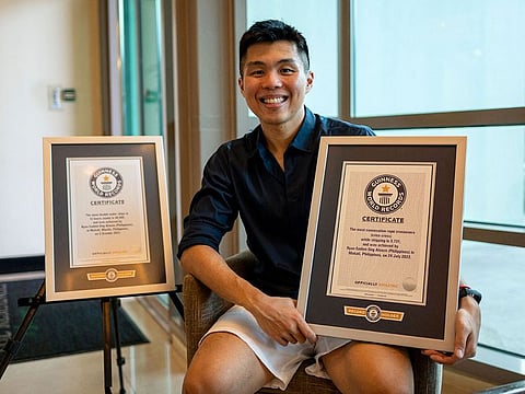 Guinness World Records holder Ryan Alonzo poses with his certificates in Makati City, Metro Manila, Philippines.