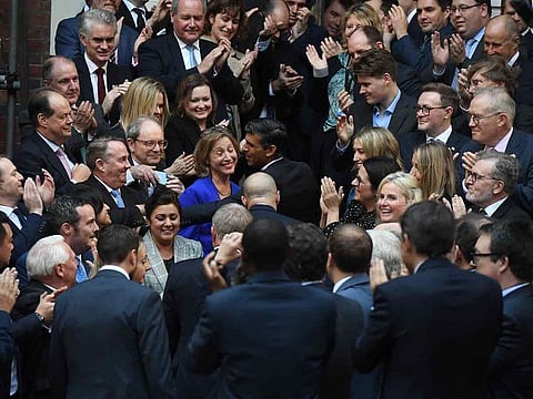 Rishi Sunak, incoming UK prime minister, center, arrives at Conservative Campaign Headquarters in London, UK, on Monday.