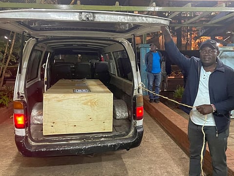 The wooden coffin containing the body of Arshad Sharif is loaded into a courtesy van at the Chiromo mortuary in Nairobi, on October 25, 2022.