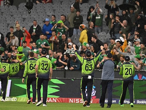 Ireland's players celebrate their win with fans during the ICC men's Twenty20 World Cup 2022 cricket match between England and Ireland at Melbourne Cricket Ground (MCG) in Melbourne.