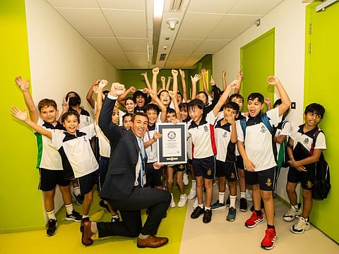 Steven Lupton, Principal Repton Abu Dhabi celebrating with students after breaking the Guinness World Record for the ‘Largest Gathering of People Dressed as Astronauts’.