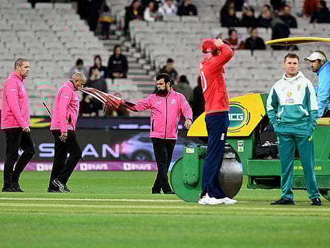 Umpire Aleem Dar (centre) inspects the pitch with match officials prior to the Twenty20 World Cup match between Australia and England at Melbourne Cricket Ground on Friday.