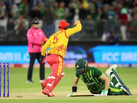 Zimbabwe's Regis Chakabva (left) celebrates victory as Pakistan's Shaheen Shah Afridi lies on the pitch at the end of their ICC mens Twenty20 World Cup 2022 match in Perth. Pakistan now must win al of their remaining matches to stand a chance of making the final.