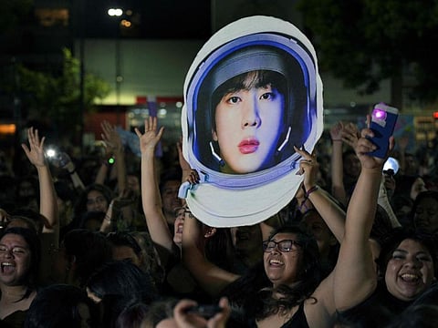 Fans gather outside the River Plate's Monumental stadium to listen to Kim Seok-jin -aka Jin- perform his single solo "The Astronaut" with British rock band Coldplay, during the third of ten concerts of their "Music of the Spheres" world tour, in Buenos Aires.