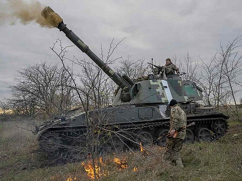 Ukrainian artillery unit members fire towards Kherson on October 28, 2022, outside of Kherson region, amid Russia's military attack on Ukraine.