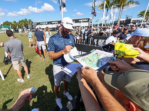 Team captain Dustin Johnson of 4 Aces GC signs autograph for fans during the quarterfinals of the LIV Golf Invitational - Miami at the Trump National in Doral, Miami on October 28, 2022.