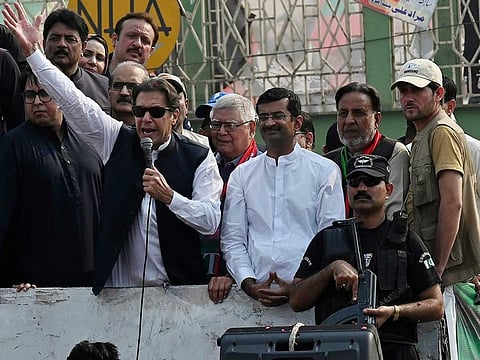 Pakistan's former Prime Minister Imran Khan, second left, addresses to his supporters at a rally in Muridke of Lahore, Pakistan, Sunday, Oct. 30 2022.