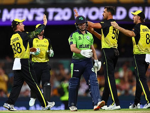 Ireland's Curtis Campher (centre) walks off as Australia's Mitchell Starc (second right) celebrates his wicket with teammates during the ICC men's Twenty20 World Cup 2022 cricket match at The Gabba. Australia won by 42 runs.