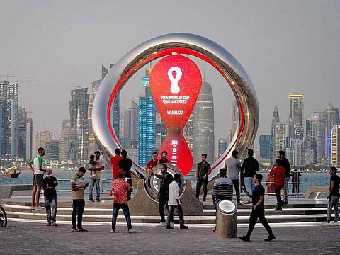 File photo: People gather around the official countdown clock showing remaining time until the kick-off of the World Cup 2022, in Doha.