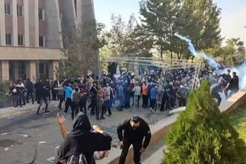 Protesters avoiding projectiles during clashes at Iran's University of North Tehran.