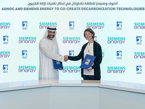 Sophie Hildebrand, CTO, ADNOC and Dr. Fahad Al Yafei, CTO, Siemens Energy Middle East exchange copies of the agreement.