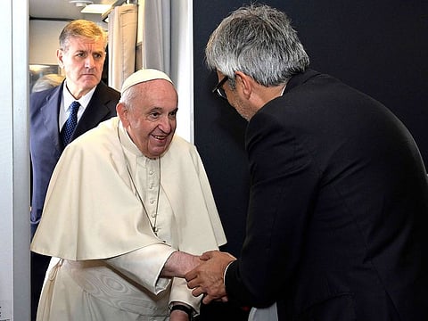 Pope Francis meets CEO of ITA Airways Fabio Maria Lazzerini as he boards a plane for his four-day visit to Bahrain, in Rome, Italy, Thursday Nov. 3, 2022.
