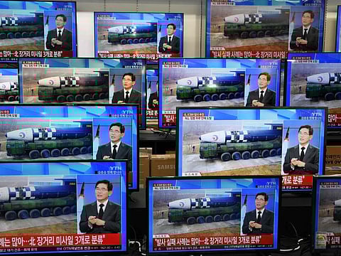 Television screens show a news report about the latest North Korean missile launch with file footage of a North Korean missile, at an electronic market in Seoul on November 3, 2022.
