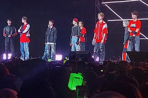 This picture taken on November 4, 2022 shows members of K-pop music group NCT127 performing in Serpong, Banten province, before the concert was stopped after chaos broke out and 30 people fainted in a crush.