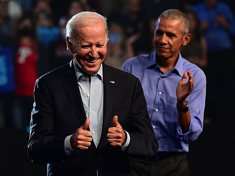 President Joe Biden (L) and former U.S. President Barack Obama.