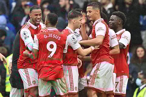 Arsenal players celebrate after the final whistle of the English Premier League match against Chelsea at Stamford Bridge in London.