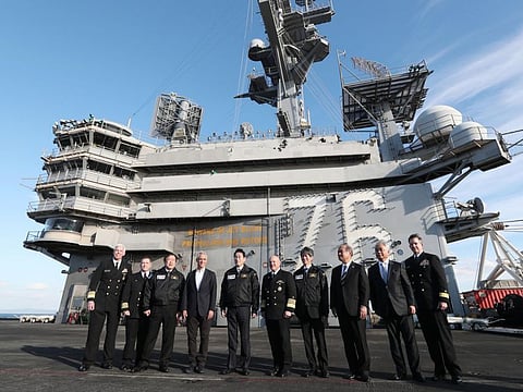 Japanese Prime Minister Fumio Kishida, US Ambassador to Japan Rahm Emanuel and Japanese Defence Minister Yasukazu Hamada on the USS Ronald Reagan, in Sagami Bay, southwest of Tokyo, on Sunday.