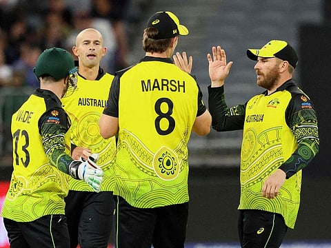 Australia’s captain Aaron Finch (right) celebrates a dismissal during the ICC men’s Twenty20 World Cup 2022 cricket match against Sri Lanka at Perth Stadium on October 25, 2022. Such celebrations were rare for the defending champions, who crashed out in the Super 12 phase.