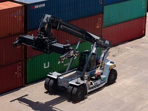 An electric container crane at work in a terminal.