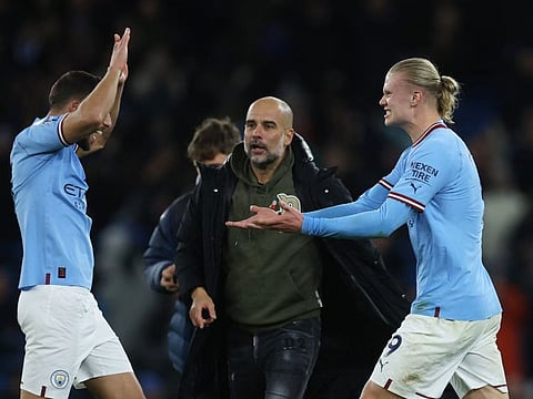 Manchester City's Ruben Dias, manager Pep Guardiola and Erling Haaland celebrate after the match against Fulham.