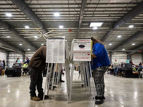 Voters fill out their ballots at the Flathead County Fairgrounds in Kalispell, Montana, Tuesday, Nov. 8, 2022.