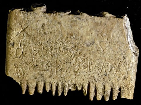 A picture taken at the conservation laboratory of the Hebrew University in Jerusalem on November 8, 2022, shows an ivory comb with a rare inscription that sheds new light on the use of Canaanite language some 3,700 years ago which has been discovered in southern Israel.