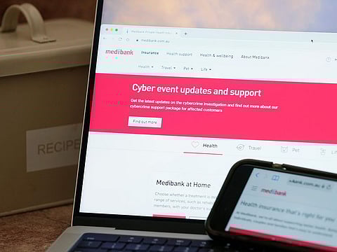 A computer and phone display pages from Medibank Private in Sydney.